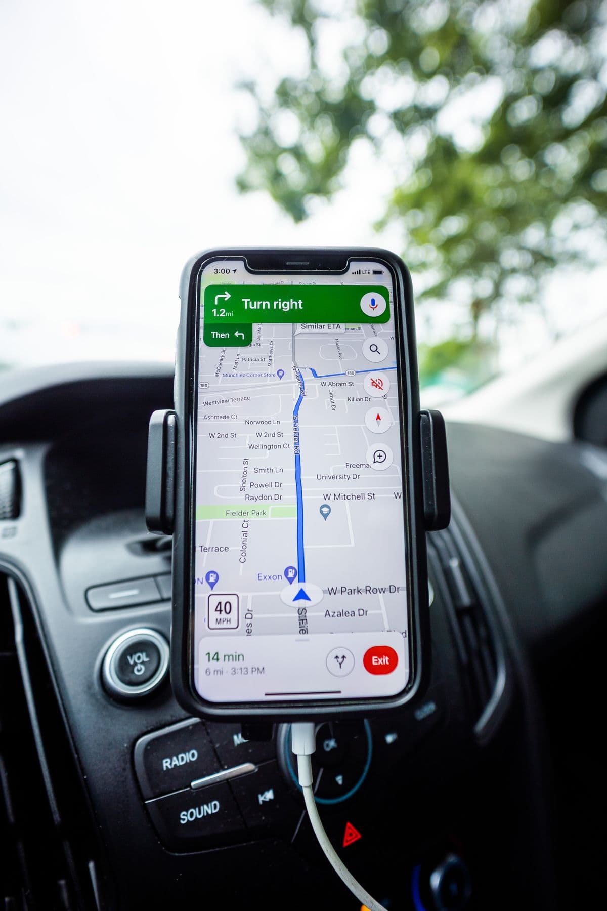 Smartphone held in a car phone mount running navigation
